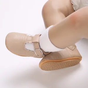 Close-up detail of beige soft-soled baby walking shoes with adjustable buckle and non-slip bottom