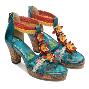 Detailed view of handmade retro leather sandals with 3D flowers and braided straps