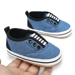 Detailed close-up of blue denim infant walking shoes with soft soles for babies aged 0-1