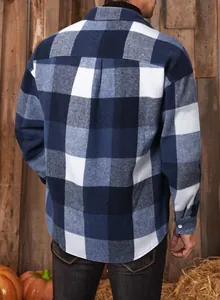 Back view of a classic navy and white plaid flannel shirt for men in a rustic setting