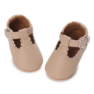 Close-up detail view of beige baby Mary Jane shoes featuring soft soles and scalloped edges