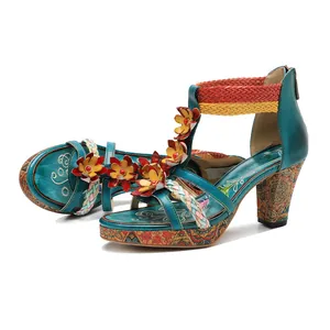 Detail shot of bohemian handmade leather sandals with 3D flowers and woven straps