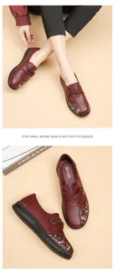 Close-up of burgundy women's leather loafers with floral embroidery and soft soles.