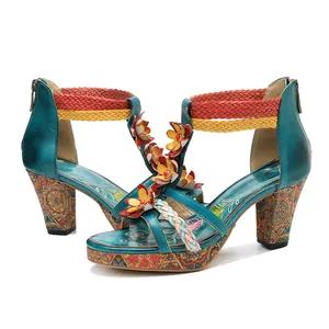 Detailed view of hand-rubbed leather sandals with floral decor and colorful straps