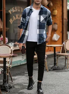 Men's blue plaid flannel shirt paired with black pants in an outdoor cafe setting