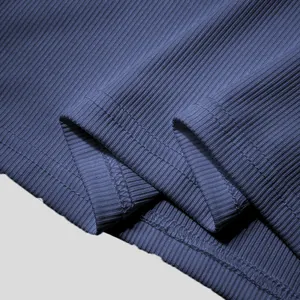 Close-up detail of blue ribbed fabric and stitching on men's sleeveless fashion vest