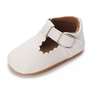 Close-up of white baby girl walker shoes with soft rubber sole and scalloped edges