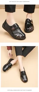 Detailed view of women's black loafers with floral embroidery and comfortable soft flat sole