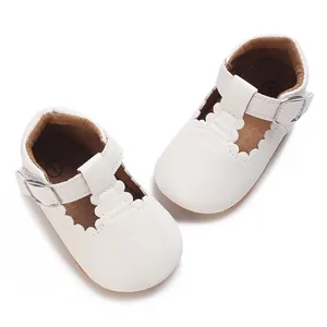Detailed top view of white soft-soled baby princess walking shoes with scalloped edges