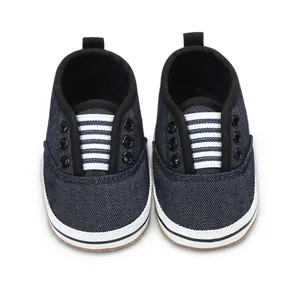 Detailed top view of navy blue denim baby walking shoes with white striped tongue
