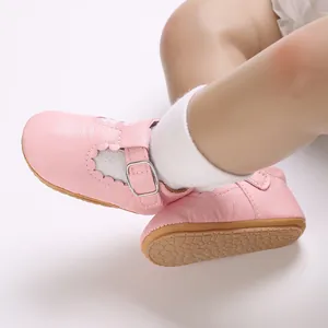 Close-up of pink soft-sole baby girl walker shoes with scalloped trim detail