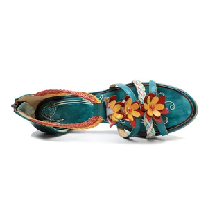 Detail view of vintage handmade leather sandal with floral decorations and braided straps