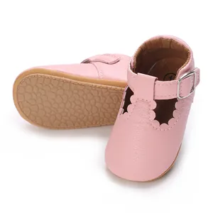 Close-up of pink baby princess walking shoes featuring scalloped edges and soft rubber sole