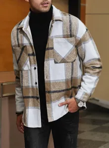 Detailed view of men's loose plaid flannel shirt with front pockets and buttons