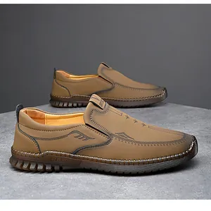 Vista lateral detallada de mocasines de cuero marrón para hombre con suela cosida a mano.
