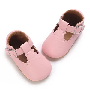 Pink infant walking shoes with soft soles and scalloped edges for baby girls
