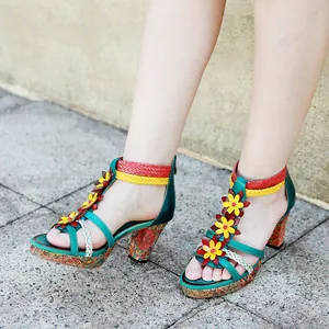 Detail of handmade vintage leather high heel sandals with colorful woven straps