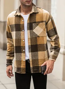 Macro view showing the soft texture and plaid pattern of a men's flannel button-down shirt.