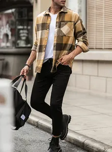 Lifestyle shot of a men's brown plaid flannel shirt with a casual urban look