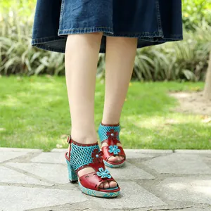 Close-up of vintage leather color-block high heel sandals with hollow floral detail