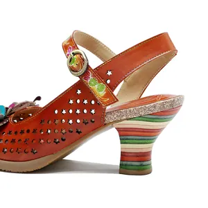Macro detail of genuine leather high heel with star cutouts and colorful striped heel