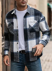 Detail shot of a men's loose-fit plaid flannel shirt with a classic lapel and pockets.