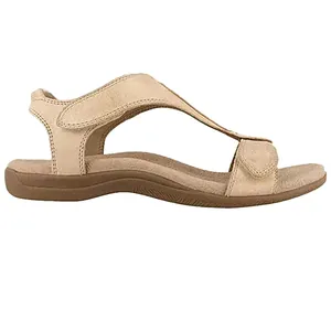 Zijaanzicht van beige platte sandalen met klittenbandsluiting en bruine rubberen zool