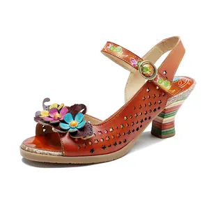 Detailed side view of orange handmade leather high heel sandal with 3D floral accents