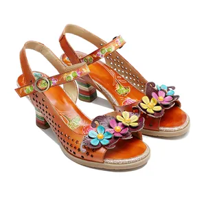 Detail view of handmade leather sandals with 3D floral accents and hollow-out design.
