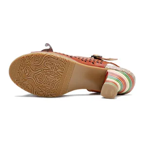 Detailed view of handmade leather sandal sole and vibrant colorful striped high heel.