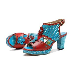 Detailed view of vintage handmade leather high heel sandals with colorful floral accents
