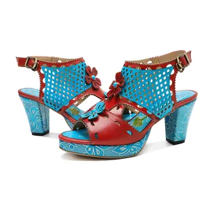 Close-up of retro color-blocked leather sandals with handmade floral and cutout details