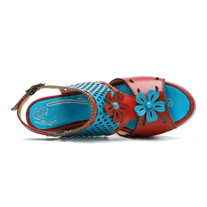 Detailed top-down view of vintage handmade leather sandals with cutout and floral accents.