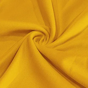 Close-up of yellow breathable mesh fabric texture for quick-dry polo shirt details