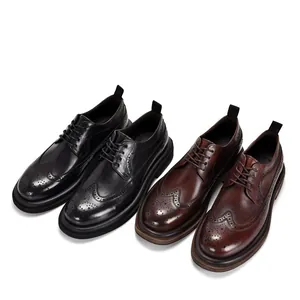 Detailed view of black and brown brogue leather dress shoes with carved patterns