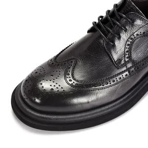 Close-up of classic black leather Brogue shoes with wingtip perforation details