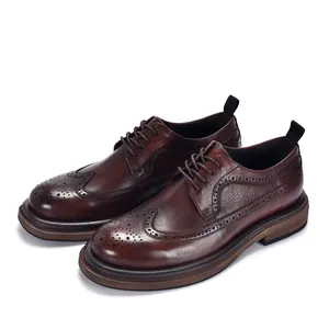 Detailed view of dark brown leather brogue shoes with classic wingtip pattern