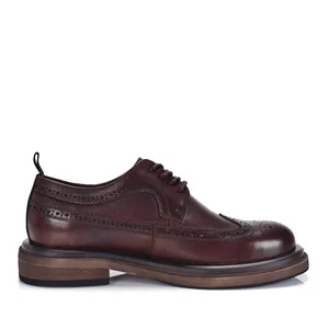 Classic vintage brown leather brogue shoes featuring intricate wingtip carving detail