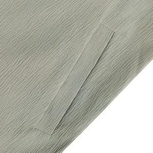 Close-up detail of textured ice silk fabric and side pocket on a wide-leg jumpsuit.