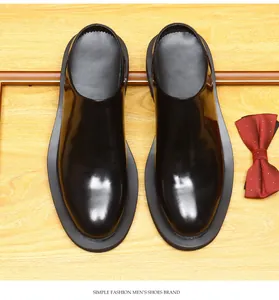 Top view of men's glossy black leather mules with thick soles and round toe design
