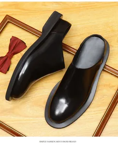 Close-up view of black glossy leather men's mules with a thick sole and British style