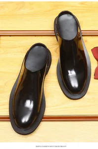 Top view of men's fashionable black shiny leather mules with thick soles and round toes
