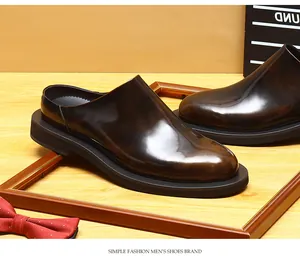 Macro view showing the glossy finish and texture of these classic men's leather mules.