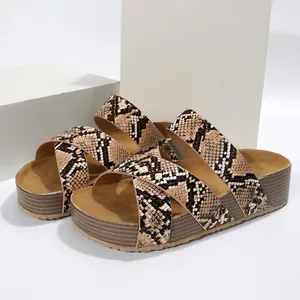 Detail view of stylish women's snake skin pattern platform sandals with cross straps