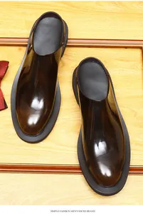 Detail view of glossy brown men's leather mules with thick soles in British style