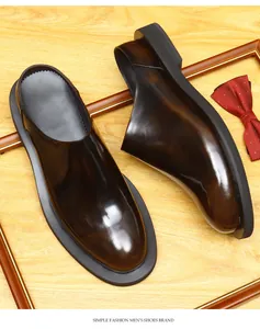 Close-up of men's burnished brown leather backless loafers with thick black soles.