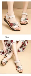Detailed macro view of women's leather sandals featuring colorful decorative leaf straps