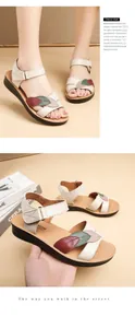 Detailed view of comfortable cowhide leather sandals with colorful leaf embroidery decor.
