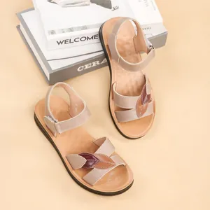 Top view of beige genuine leather sandals with leaf patterns and soft flat soles