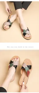 Detailed view of women's leather sandals featuring multi-colored leaf pattern straps design